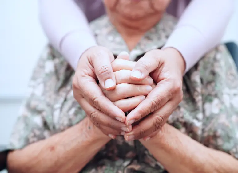 Comforting embrace of senior hands